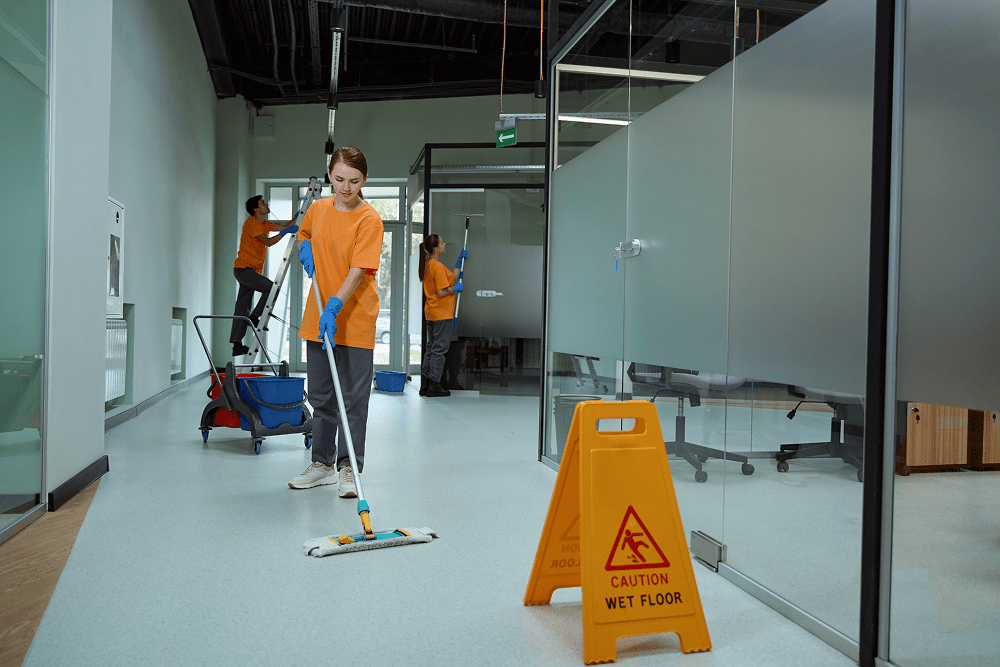 Cleaning crew mopping office floor