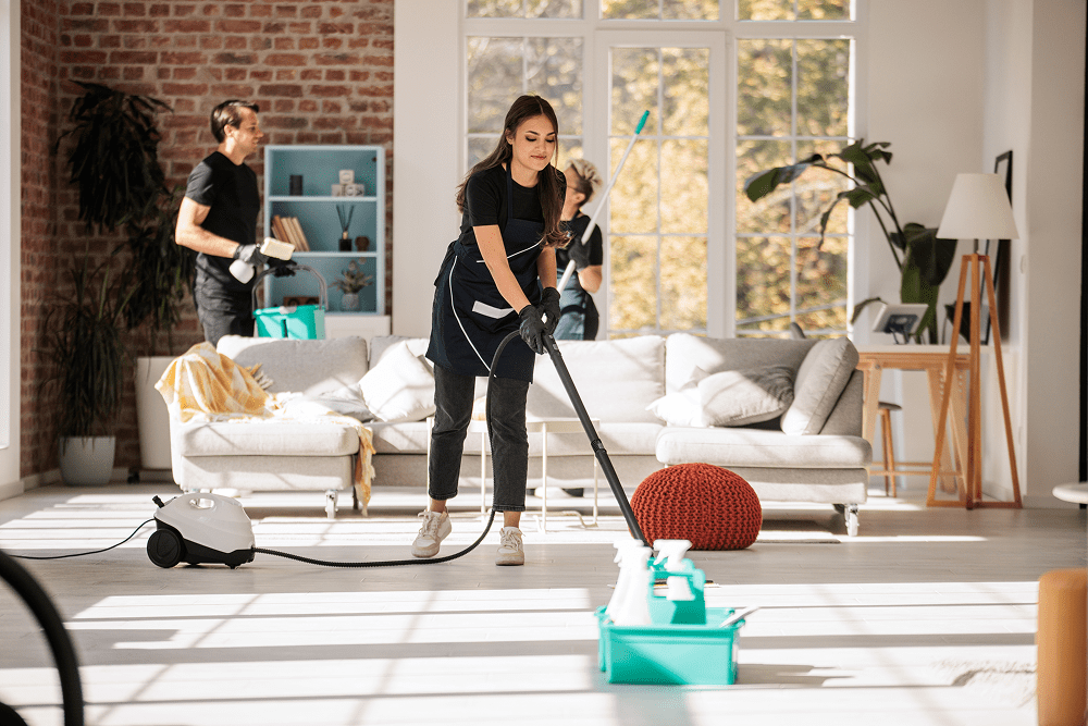 Group cleaning sunny, open-concept room