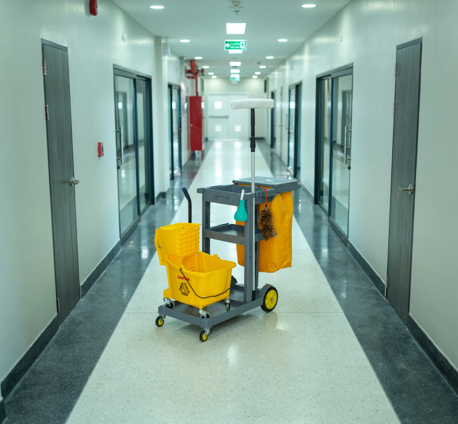 Yellow mop bucket on cart